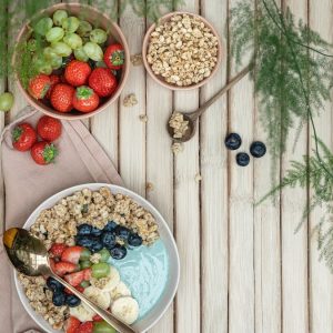 a table topped with bowls of fruit and cereal